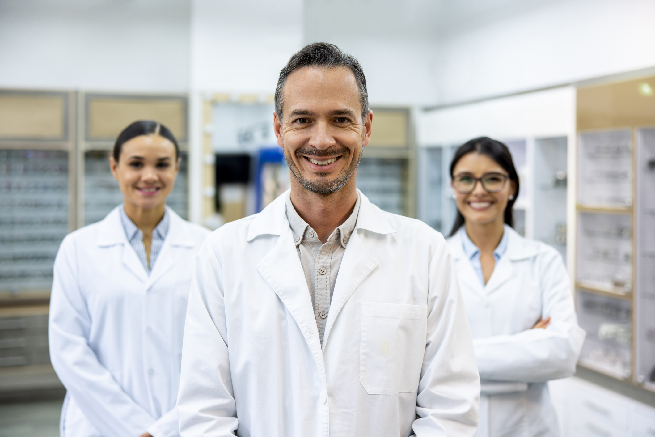 Team of opticians working at an ophthalmologist shop